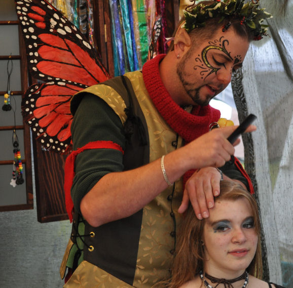 A butterfly adds more braid art to Tara's hair.