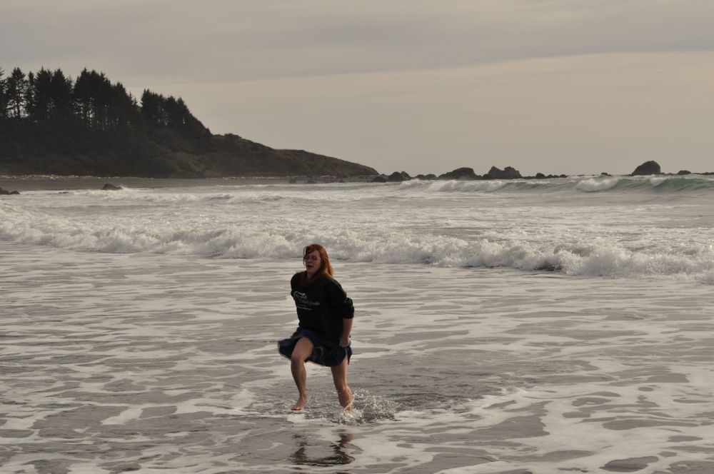 Miss Tara splashes through the waves in a skirt.