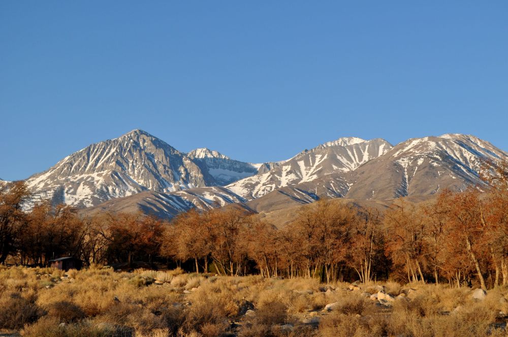 The campground stretches along the base of the hills, beneath those trees. You can see one of the toilets on the left.