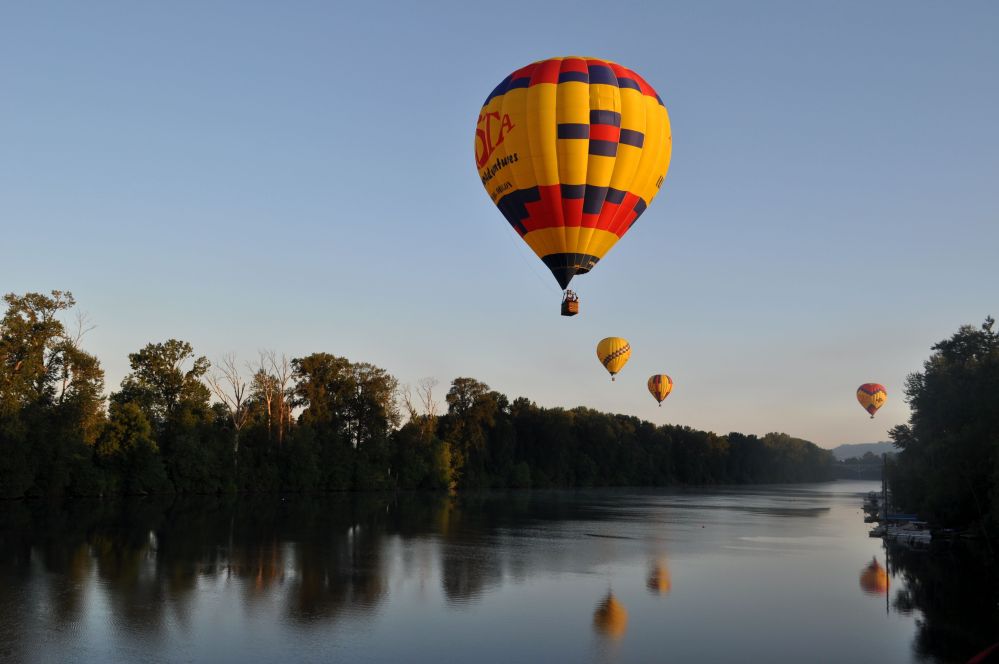 balloons hover above the Willamette River
