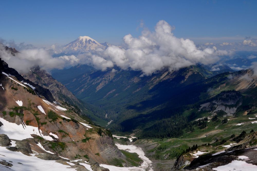 Steep valley with Mt. Rainier rising in the background to 14,410 feet. Goat Lake is in the cirque to the left.