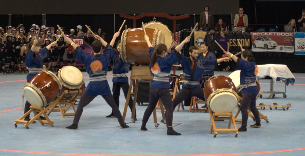 Portland Taiko in their finale: eating person beating multiple drums
