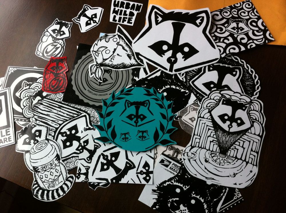 A pile of unused raccoon stickers just waiting to find a home.