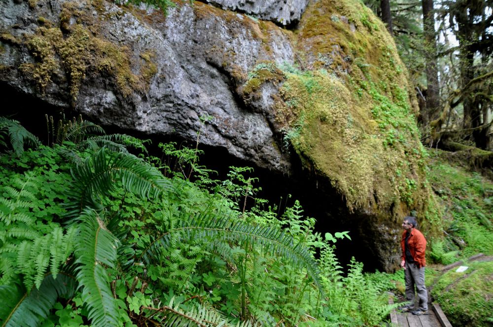 Arno stands on the trail and looks up at House Rock