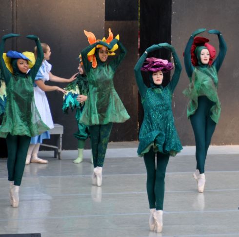 Alice scolds a weed in the back of the flower garden.