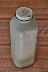 A plastic juice bottle filled with volcanic ash.