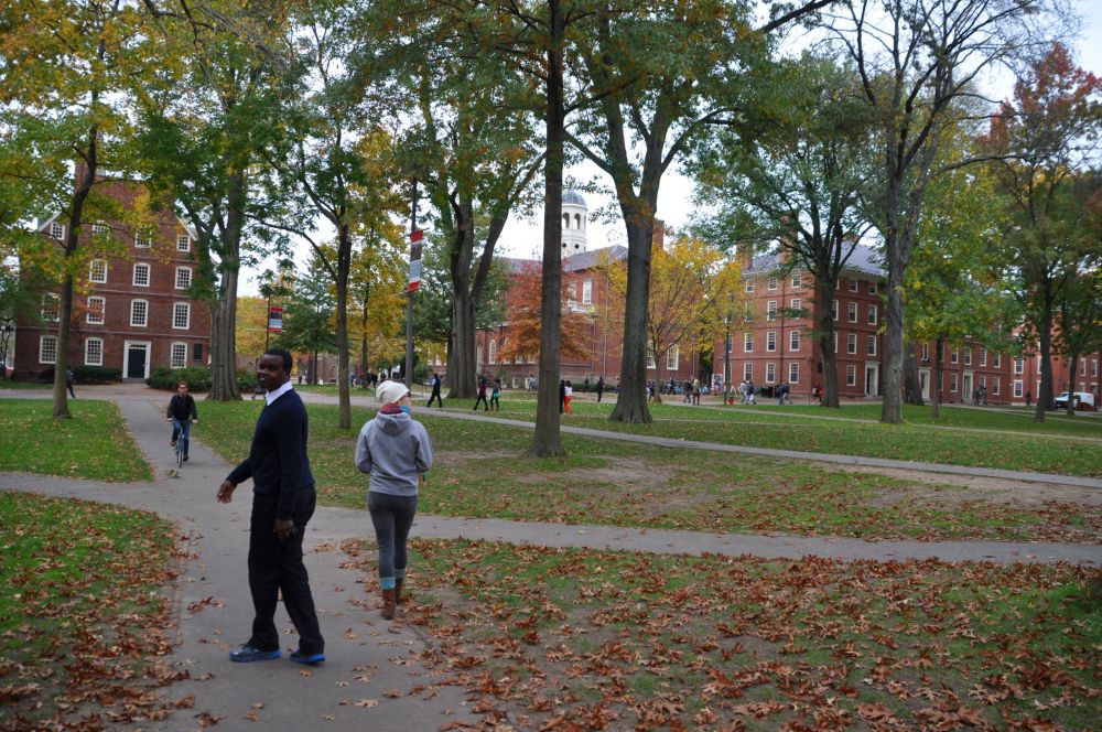 R and Tara walk through a Harvard courtyard