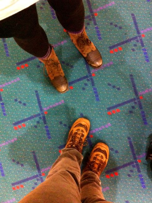 Our feet and shadows on the PDX carpet.
