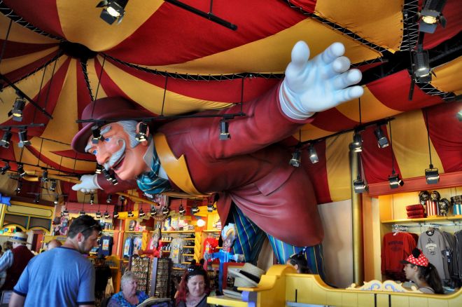 A larger-than-life ringmaster holds up a tent in Disney California Adventure Park.