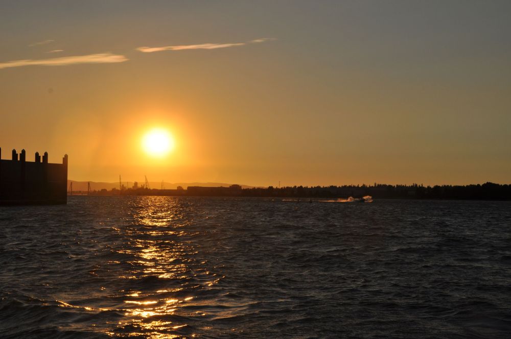 The air was warm. The water was warm. The people were warm - even the talking and laughter were like a blanket around me. In this softness, the copper sun sank into the water.