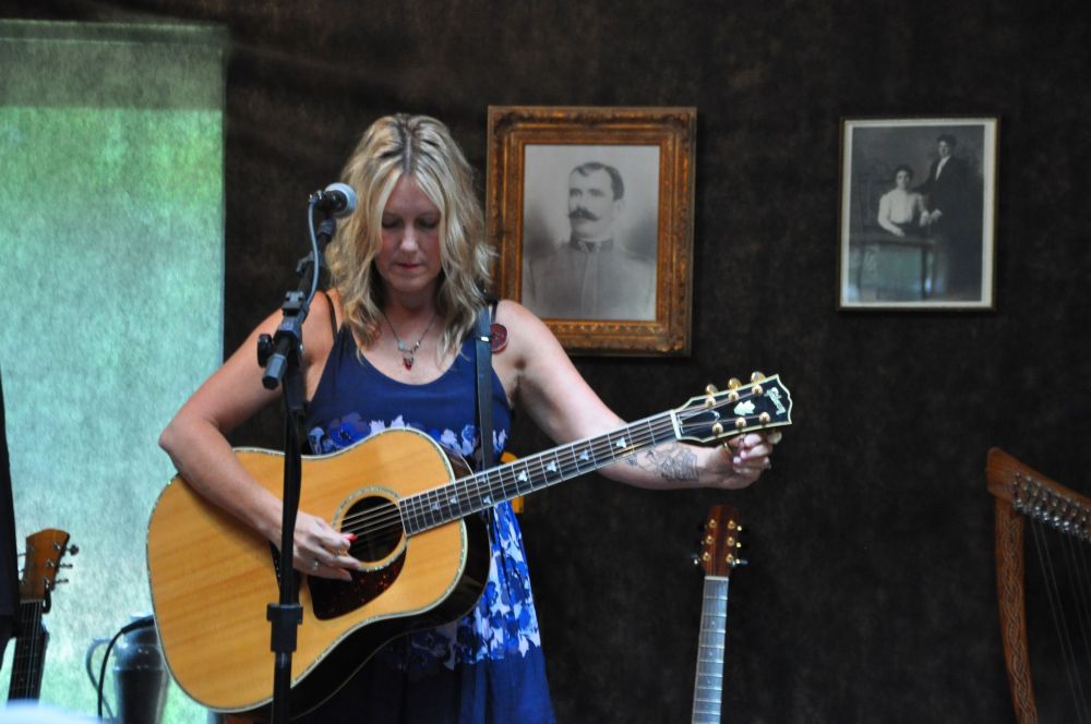 Terry Holder tunes her guitar.