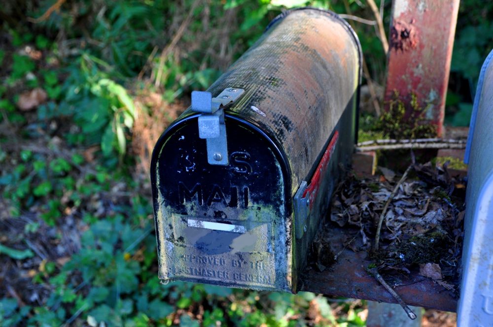 The old, sad mailbox. It had a white strip of tape with one number on it, crossed out, and a different handwritten number in felt pen beneath.