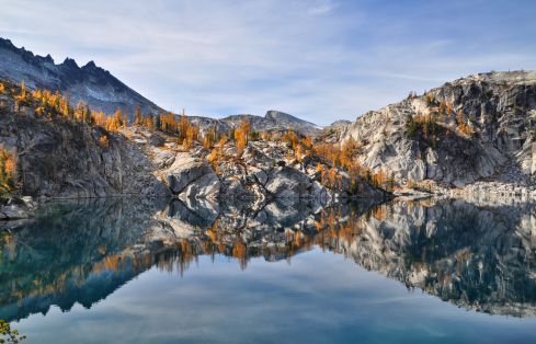 Lake Viviane reflecting. The yellow trees are Tamarack to me, Larch to people who call things by their proper names.