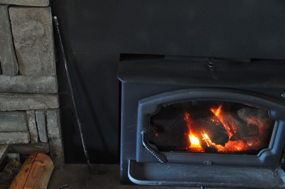 Metal pokers are best. Can you see it, leaning against the bricks?