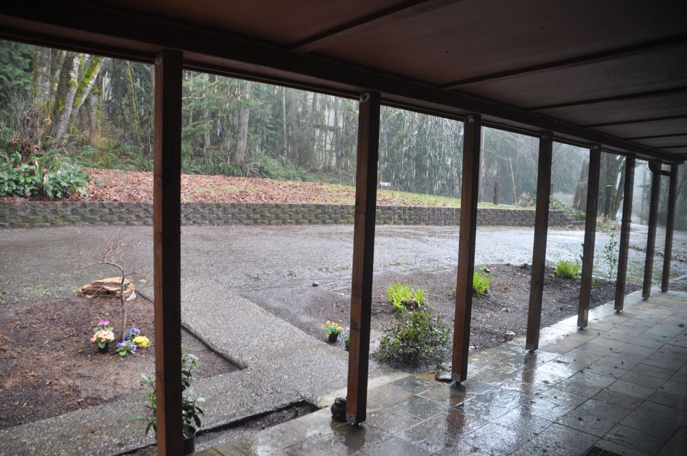 The rain was gushing today, but the ample front porch keeps the front of the house dry.