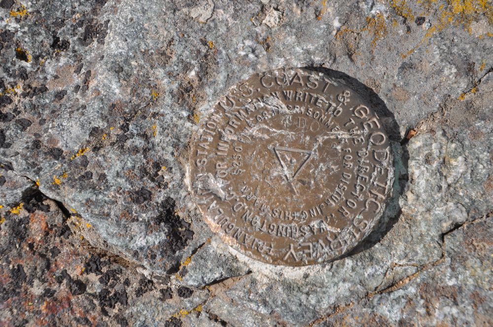 A rather battered geodetic survey marker. Now that would be a fun game to play on your phone: find geodetic survey markers!